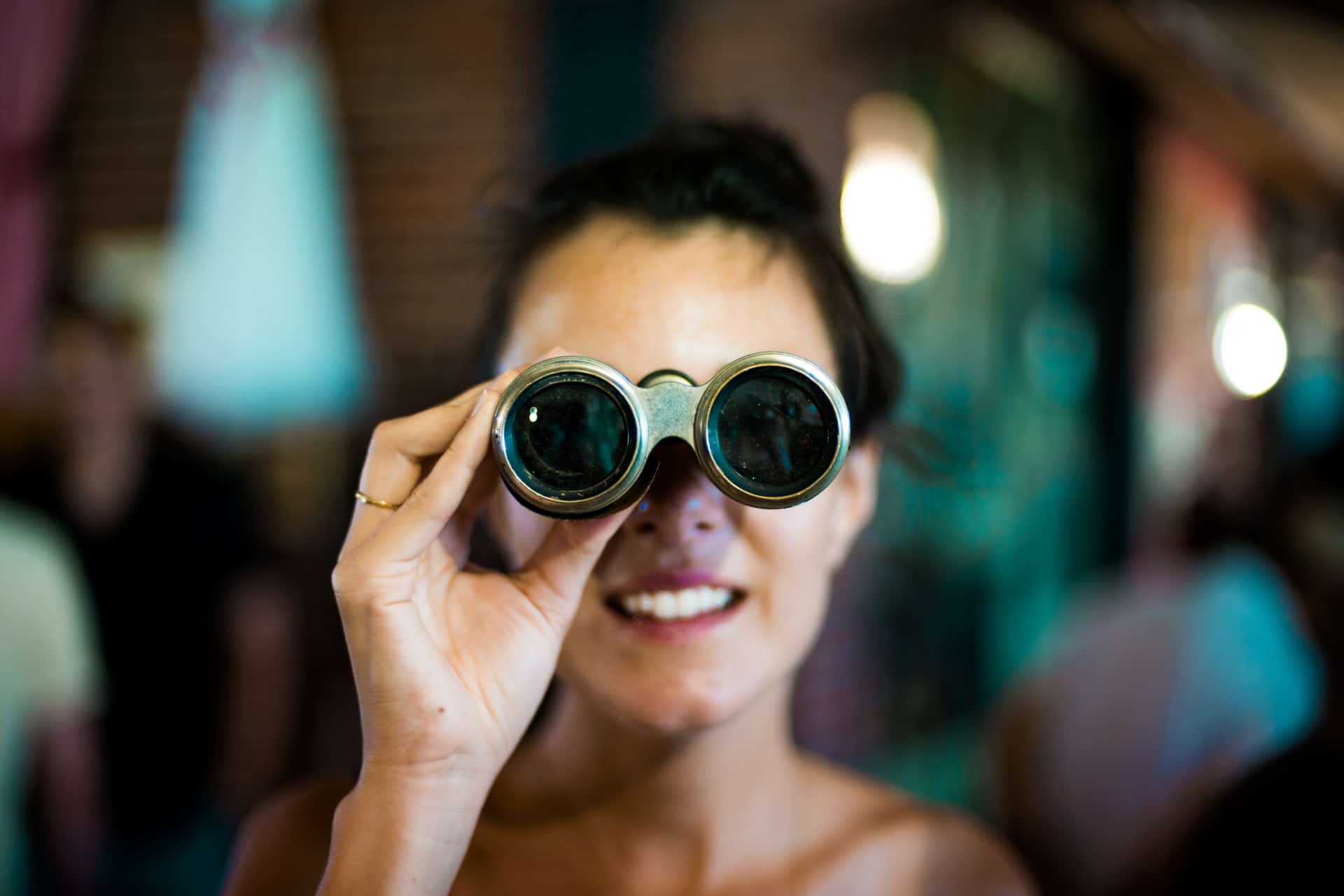 a girl looking through Binoculars
