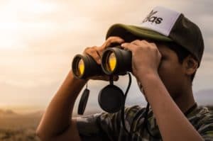 a guy looking through Binoculars