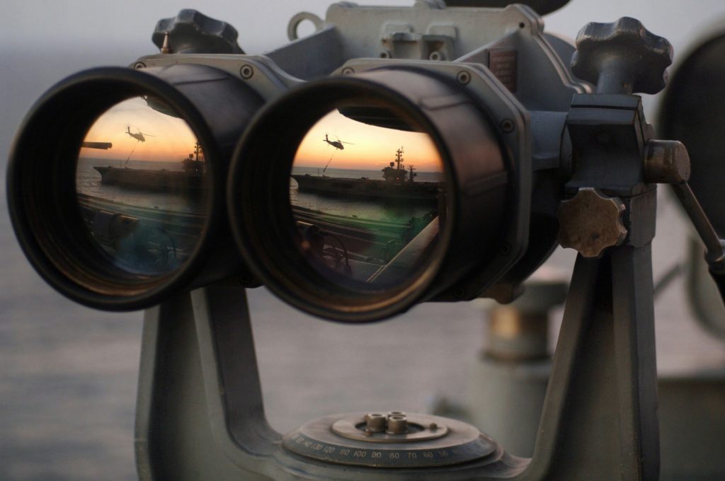 Big binoculars mounted on a stand and overlooking the sea