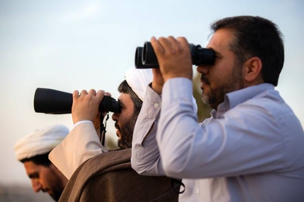 Men using binoculars