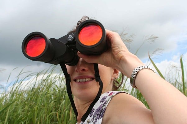 Woman holding a binoculars